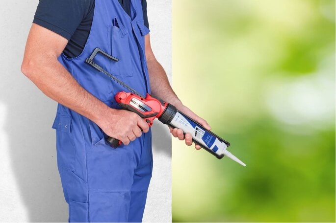 Man holding sustainable SABA sealant in front of green background