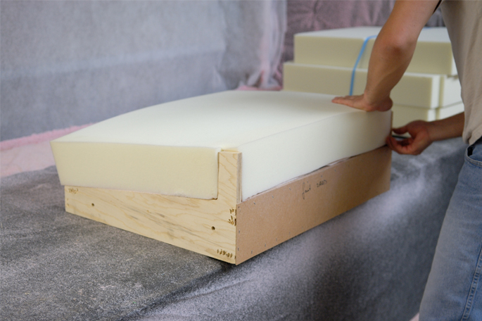 Man assembling furniture piece with water-based adhesive