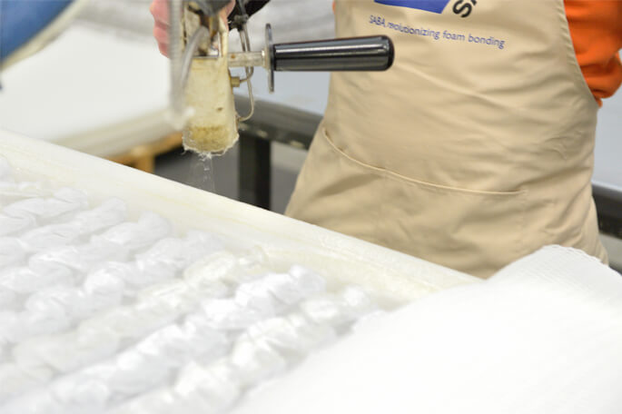 Man applying SABA hot melt adhesive