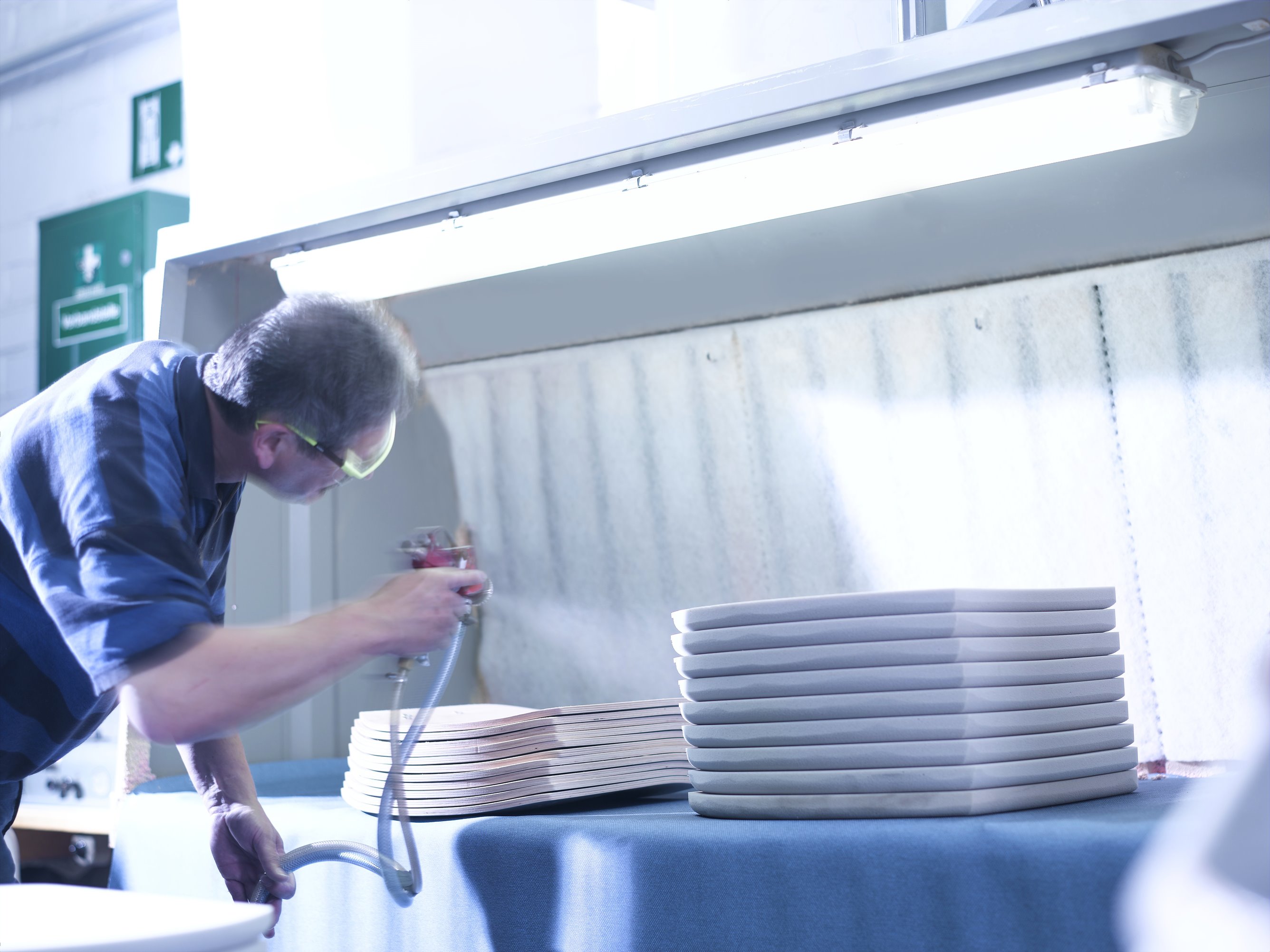 Man applying adhesives with spray gun